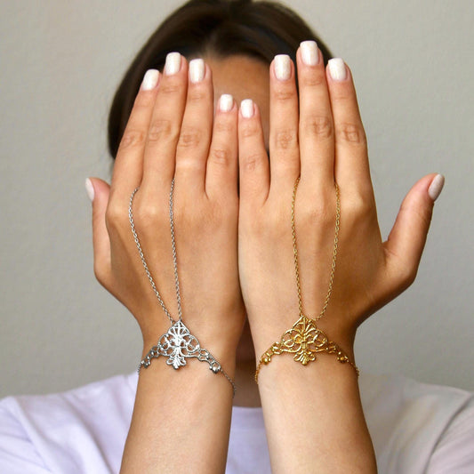 delicate boho hand chain bracelet ring with intricate filigree detail worn on a hand, featuring fine chains and a feminine, elegant design