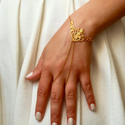 delicate boho hand chain bracelet ring with intricate filigree detail worn on a hand, featuring fine chains and a feminine, elegant design